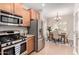 Modern kitchen with stainless steel appliances and an adjacent dining area at 1414 W Alder Rd, Queen Creek, AZ 85140