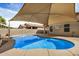 Sparkling pool and relaxing outdoor sunshade in backyard at 1414 W Alder Rd, Queen Creek, AZ 85140