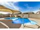 Inviting pool with sunshade offering a relaxing backyard experience at 1414 W Alder Rd, Queen Creek, AZ 85140