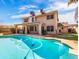 Exterior showcasing the beautiful pool with a cleaning system and a covered patio for relaxing and entertaining at 14317 N 78Th Dr, Peoria, AZ 85381