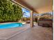 This backyard features a pool and a spa under a covered patio at 14317 N 78Th Dr, Peoria, AZ 85381