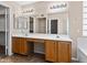 This bathroom features dual sinks with wooden cabinets and a large mirror at 14317 N 78Th Dr, Peoria, AZ 85381