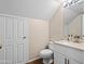 Cozy bathroom featuring a toilet, sink, and a white vanity at 14317 N 78Th Dr, Peoria, AZ 85381