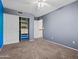 This bedroom features neutral carpet and a closet with built in shelves at 14317 N 78Th Dr, Peoria, AZ 85381