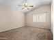 This bedroom features neutral carpet, a window and vaulted ceilings at 14317 N 78Th Dr, Peoria, AZ 85381