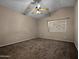 This bedroom features neutral carpet, a window and vaulted ceilings at 14317 N 78Th Dr, Peoria, AZ 85381