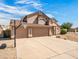 Inviting two-story home featuring a spacious driveway and a basketball hoop for outdoor fun at 14317 N 78Th Dr, Peoria, AZ 85381