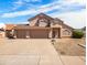 Charming two-story home featuring a three-car garage and low-maintenance desert landscaping at 14317 N 78Th Dr, Peoria, AZ 85381