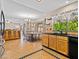 Spacious kitchen with dining area, oak cabinets, black countertops and view to the backyard at 14317 N 78Th Dr, Peoria, AZ 85381
