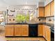 Kitchen featuring a black countertop, a window to the outside, and a view to the backyard pool at 14317 N 78Th Dr, Peoria, AZ 85381