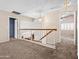 Second floor hallway view with natural light, carpet, and access to multiple rooms at 14317 N 78Th Dr, Peoria, AZ 85381