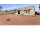 A spacious backyard features a covered patio, desert landscaping, and ample room for outdoor living and entertainment at 14527 W Marcus Dr, Surprise, AZ 85374