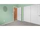 Bedroom showcasing light green paint, carpeting, with closet access at 14527 W Marcus Dr, Surprise, AZ 85374