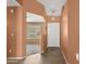 Inviting foyer with neutral paint tones, decorative lighting, and tiled flooring at 14527 W Marcus Dr, Surprise, AZ 85374