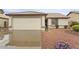 Charming single-story home featuring a two car garage and low maintenance desert landscaping at 14527 W Marcus Dr, Surprise, AZ 85374