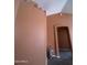 Warm hallway with decorative accents, painted in an earth tone color to complement the flooring and decor at 14527 W Marcus Dr, Surprise, AZ 85374