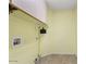 Bright laundry room with broom and overhead cabinets at 14527 W Marcus Dr, Surprise, AZ 85374
