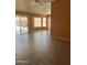 This bright living room features neutral tile flooring, and large windows for ample natural light at 14527 W Marcus Dr, Surprise, AZ 85374