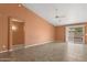 Open-concept living room featuring a ceiling fan, neutral paint, and a sliding door to the backyard at 14527 W Marcus Dr, Surprise, AZ 85374