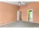 Spacious main bedroom with a ceiling fan and ensuite bathroom and large closet at 14527 W Marcus Dr, Surprise, AZ 85374