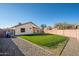 Green backyard featuring a gravel border and a block privacy fence at 14717 N 130Th Ln, El Mirage, AZ 85335