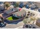 Aerial shot of a home featuring a well-kept backyard lawn and privacy fence within a quiet neighborhood at 14717 N 130Th Ln, El Mirage, AZ 85335