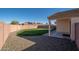 Fully-fenced backyard featuring lush green grass and a gravel border at 14717 N 130Th Ln, El Mirage, AZ 85335