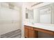 Bathroom featuring updated vanity, sink, lighting, mirrors, and walk-in closet at 14717 N 130Th Ln, El Mirage, AZ 85335