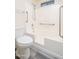 Accessible bathroom featuring updated toilet, shower with grab bars, and updated fixtures at 14717 N 130Th Ln, El Mirage, AZ 85335