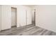 This bedroom features a spacious closet, light gray flooring, and neutral-colored walls at 14717 N 130Th Ln, El Mirage, AZ 85335