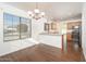 The eat-in kitchen features modern appliances, a breakfast bar, wood cabinetry, and updated fixtures at 14717 N 130Th Ln, El Mirage, AZ 85335