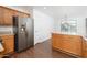 Kitchen area featuring wood cabinets, a stainless steel refrigerator, and laminate flooring at 14717 N 130Th Ln, El Mirage, AZ 85335