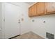 Convenient laundry room includes built-in cabinets for storage space at 14717 N 130Th Ln, El Mirage, AZ 85335