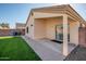 Covered patio with paved walkway overlooking the grassy backyard at 14717 N 130Th Ln, El Mirage, AZ 85335