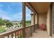Balcony with wood railing overlooks neighborhood; features cozy outdoor seating and pleasant views at 15239 W Alexandria Way, Surprise, AZ 85379