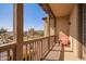 Balcony featuring a peach chair, wooden railing, and outdoor decor at 15239 W Alexandria Way, Surprise, AZ 85379