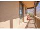 Balcony featuring a peach chair, wooden railing, and tile floor at 15239 W Alexandria Way, Surprise, AZ 85379