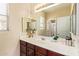 Bathroom featuring a large mirror, wood vanity, and decor at 15239 W Alexandria Way, Surprise, AZ 85379