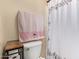 Bathroom featuring toilet, shower with decorative curtain, and wood side table at 15239 W Alexandria Way, Surprise, AZ 85379