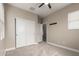 Bedroom with carpeting, baseboards, ceiling fan, windows with blinds, closet and neutral paint on the walls at 15239 W Alexandria Way, Surprise, AZ 85379