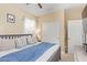 Bright bedroom showcasing a closet, closet doors, bed with gray frame and blue blanket at 15239 W Alexandria Way, Surprise, AZ 85379