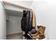 Walk-in closet includes a wooden clothes bar, carpeted floor, and room for storage and boots at 15239 W Alexandria Way, Surprise, AZ 85379