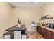 View of the dining area with dark wood table and seating, granite counters, and light beige walls at 15239 W Alexandria Way, Surprise, AZ 85379