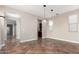 Open dining room with tile floors, neutral walls, and decorative pendant lighting at 15239 W Alexandria Way, Surprise, AZ 85379