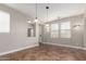 Open-concept dining room with tile floors, neutral walls, and lots of natural light from large windows at 15239 W Alexandria Way, Surprise, AZ 85379