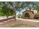 Attractive home with a large arched window, manicured yard, sidewalk and mature shade trees at 15239 W Alexandria Way, Surprise, AZ 85379