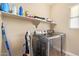 Laundry room with washer and dryer, shelving, and cleaning supplies at 15239 W Alexandria Way, Surprise, AZ 85379