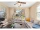 Comfortable living room featuring plush sofas, a large arched window, and stylish decor, perfect for relaxation at 15239 W Alexandria Way, Surprise, AZ 85379