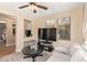 Cozy living room with comfortable seating, a ceiling fan, and natural light, creating a relaxing ambiance at 15239 W Alexandria Way, Surprise, AZ 85379