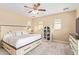 Comfortable main bedroom with neutral carpet, ceiling fan, and lots of natural light from windows at 15239 W Alexandria Way, Surprise, AZ 85379
